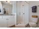 Corner shower in neutral color with glass doors, and vanity with storage at 328 Stonemont Dr, Atlanta, GA 30305