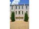 Townhome exterior with brick facade, garages, herringbone driveway, and manicured evergreens at 328 Stonemont Dr, Atlanta, GA 30305
