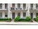 Charming townhome with white brick, a balcony, and a well-manicured front garden at 328 Stonemont Dr, Atlanta, GA 30305