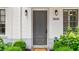 Close-up of charming townhome front door with white brick and a well-manicured front garden at 328 Stonemont Dr, Atlanta, GA 30305