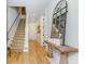 Hallway features hardwood floors, a staircase, artwork, and a large mirror at 328 Stonemont Dr, Atlanta, GA 30305