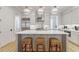 This gourmet kitchen features a spacious island with seating, custom cabinetry, and stainless steel appliances at 328 Stonemont Dr, Atlanta, GA 30305