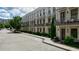 Street view of townhomes with white brick, balconies, gray doors, and well-manicured gardens at 328 Stonemont Dr, Atlanta, GA 30305