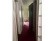 Narrow hallway with doors and carpet, leading to another room with a window at 6354 Shannon Pkwy # 12D, Union City, GA 30291