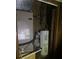 Compact utility room housing water heater and HVAC unit with visible wiring at 6354 Shannon Pkwy # 12D, Union City, GA 30291