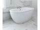 Close-up of a modern white bathtub on marble-like tile, showcasing sleek design at 1631 Overlook Nw Way # 2, Atlanta, GA 30318