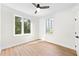 Well-lit bedroom featuring hardwood floors, large windows, and a modern ceiling fan at 1631 Overlook Nw Way # 2, Atlanta, GA 30318