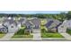 An aerial view of a suburban neighborhood featuring grey and white two-story homes with well-manicured lawns at 13568 Whitman Lane, Covington, GA 30014