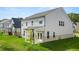 Spacious backyard features a covered patio, lush green lawn, and stylish two-story home at 13568 Whitman Lane, Covington, GA 30014