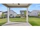 View of the backyard from the covered patio, showcasing a spacious grassy area at 13568 Whitman Lane, Covington, GA 30014