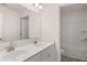 Bright bathroom featuring a double sink vanity and separate area with a toilet and tub at 13568 Whitman Lane, Covington, GA 30014