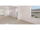 Bright bedroom with neutral carpet, multiple windows, and an open doorway leading to the bathroom at 13568 Whitman Lane, Covington, GA 30014
