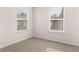 Cozy bedroom with neutral carpet and two windows providing natural light at 13568 Whitman Lane, Covington, GA 30014