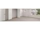 Spacious bedroom with multiple doors, neutral carpeting, and two windows with a neighborhood view at 13568 Whitman Lane, Covington, GA 30014