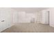 Spacious bonus room with neutral carpet and two doors, providing ample space for activities at 13568 Whitman Lane, Covington, GA 30014