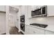 Close-up of kitchen appliances: double oven, gas stovetop, and stainless steel microwave at 13568 Whitman Lane, Covington, GA 30014
