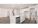 Modern kitchen with an island, stainless steel appliances, and luxury vinyl plank flooring at 13568 Whitman Lane, Covington, GA 30014