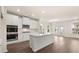 Modern kitchen with white cabinets, stainless steel appliances, and a large island at 13568 Whitman Lane, Covington, GA 30014