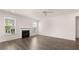 Well-lit living room with fireplace, complemented by hardwood floors and natural light at 13568 Whitman Lane, Covington, GA 30014