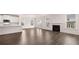 Living room with hardwood floors, fireplace, and bright, natural light from windows at 13568 Whitman Lane, Covington, GA 30014