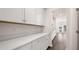 Walk-in pantry features ample storage with white cabinetry and quartz countertops at 13568 Whitman Lane, Covington, GA 30014