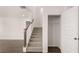 Staircase with wooden railing, leading to the second floor, adjacent to a closet with an open door at 13568 Whitman Lane, Covington, GA 30014