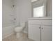 Bathroom featuring a shower-tub combo, white vanity, and neutral tile flooring at 500 Charleston Pl, Villa Rica, GA 30180