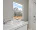 Bright bathroom with a large window, white vanity, and tub/shower combo at 500 Charleston Pl, Villa Rica, GA 30180