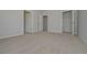 View of a bedroom with neutral colored walls, carpet and doors leading to closets at 500 Charleston Pl, Villa Rica, GA 30180