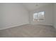Bright bedroom featuring neutral carpet and a window letting in natural light at 500 Charleston Pl, Villa Rica, GA 30180