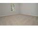 A carpeted bedroom with natural light and neutral colored walls at 500 Charleston Pl, Villa Rica, GA 30180
