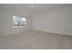 Bright bedroom with a neutral carpet and natural light from a large window at 500 Charleston Pl, Villa Rica, GA 30180