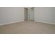 Bedroom with neutral colored walls and carpet with access to a large closet at 500 Charleston Pl, Villa Rica, GA 30180