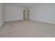 A carpeted bedroom with neutral colored walls and open doorways to other rooms at 500 Charleston Pl, Villa Rica, GA 30180