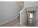 Staircase with wood-look flooring, neutral walls, and white trim, leading to the upper level at 500 Charleston Pl, Villa Rica, GA 30180