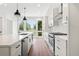 Spacious kitchen featuring white cabinets, a large island with seating, stainless steel appliances, and hardwood floors at 1641 Overlook Nw Way # 7, Atlanta, GA 30318