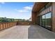 Wide patio with wood-grain flooring, brown railings, and sliding-glass doors offering expansive outdoor living and city views at 1641 Overlook Nw Way # 7, Atlanta, GA 30318