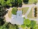 Aerial view of a well-manicured property with a circular driveway and a meticulously maintained lawn at 2166 Tanglewood Dr, Snellville, GA 30078