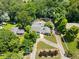 Aerial view of a secluded home surrounded by mature trees with a long, winding driveway at 2166 Tanglewood Dr, Snellville, GA 30078