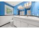 Bright bathroom with double sinks, subway tile, and black and white mosaic tiled floors at 2166 Tanglewood Dr, Snellville, GA 30078