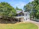 Two-story home with white siding, screened porch, attached garage, and manicured lawn at 2166 Tanglewood Dr, Snellville, GA 30078