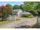 Charming two-story home with a white picket fence, mature trees, and a well-manicured lawn at 2166 Tanglewood Dr, Snellville, GA 30078