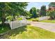 Scenic view of a home with a white picket fence, lush greenery, and a long driveway at 2166 Tanglewood Dr, Snellville, GA 30078