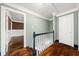 Upstairs hallway showing hardwood floors and access to other parts of the home at 2166 Tanglewood Dr, Snellville, GA 30078
