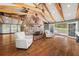 Living room with a stone fireplace and hardwood floors at 2166 Tanglewood Dr, Snellville, GA 30078
