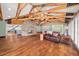 Spacious living room with hardwood floors, stone fireplace, exposed beams, and natural light at 2166 Tanglewood Dr, Snellville, GA 30078
