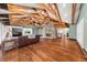 Cozy living room with hardwood floors, stone fireplace, and exposed wood beam ceiling at 2166 Tanglewood Dr, Snellville, GA 30078