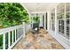 Inviting front porch featuring stone flooring and rocking chairs at 2166 Tanglewood Dr, Snellville, GA 30078