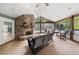 Relaxing screened porch with a stone fireplace, perfect for enjoying the outdoors at 2166 Tanglewood Dr, Snellville, GA 30078