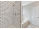 Bathroom featuring a white tiled shower, a soaking tub, and a white door at 2505 Hamilton Parc Ln, Buford, GA 30519